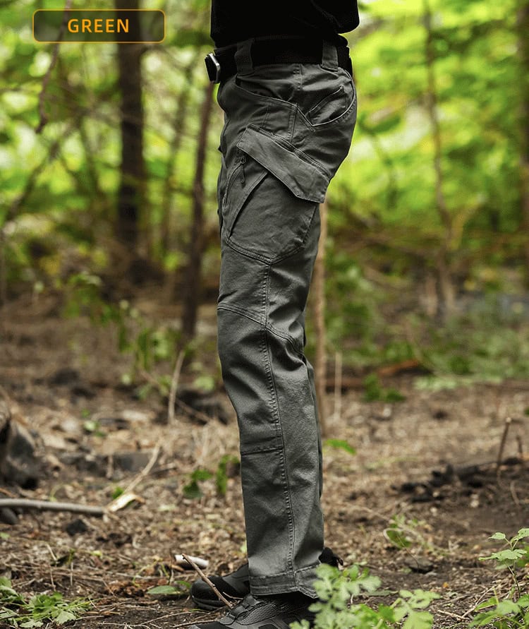 Side profile of a professional wearing the green Onken IX9 lightweight tactical pants, highlighting the ergonomic cut and pocket layout.