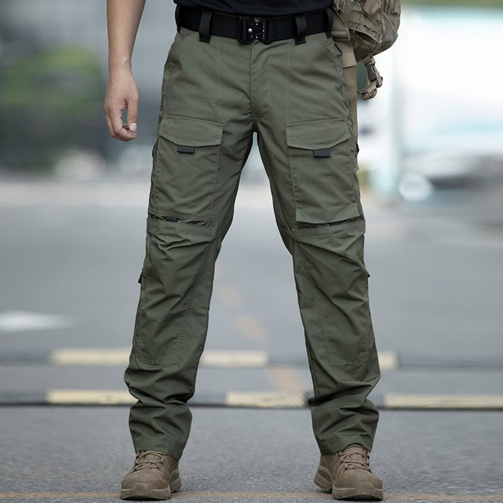 A professional wearing the olive green Onken Beetle durable tactical pants, demonstrating their classic, relaxed fit and rugged appearance.
