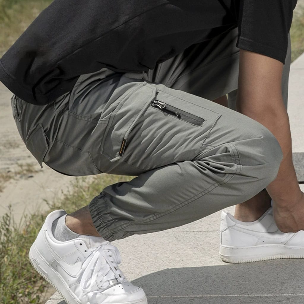 Operator wearing the grey Onken tactical jogger pants, demonstrating their superior mobility and athletic fit during dynamic movement.