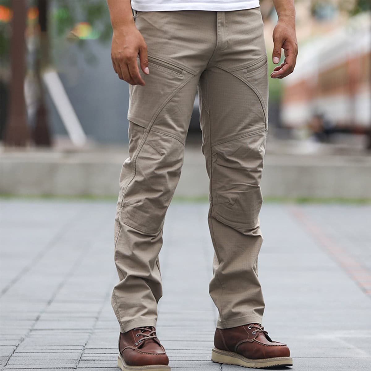 A professional wearing the khaki Strider stretch tactical pants, showcasing their modern, athletic fit and professional appearance for uniform use.