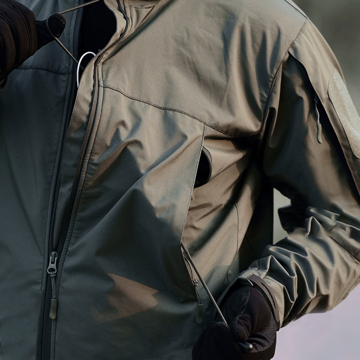 Close-up of a hand in the warm, fleece-lined pocket of the Onken 3-in-1 tactical jacket, a key feature for comfort in cold weather.
