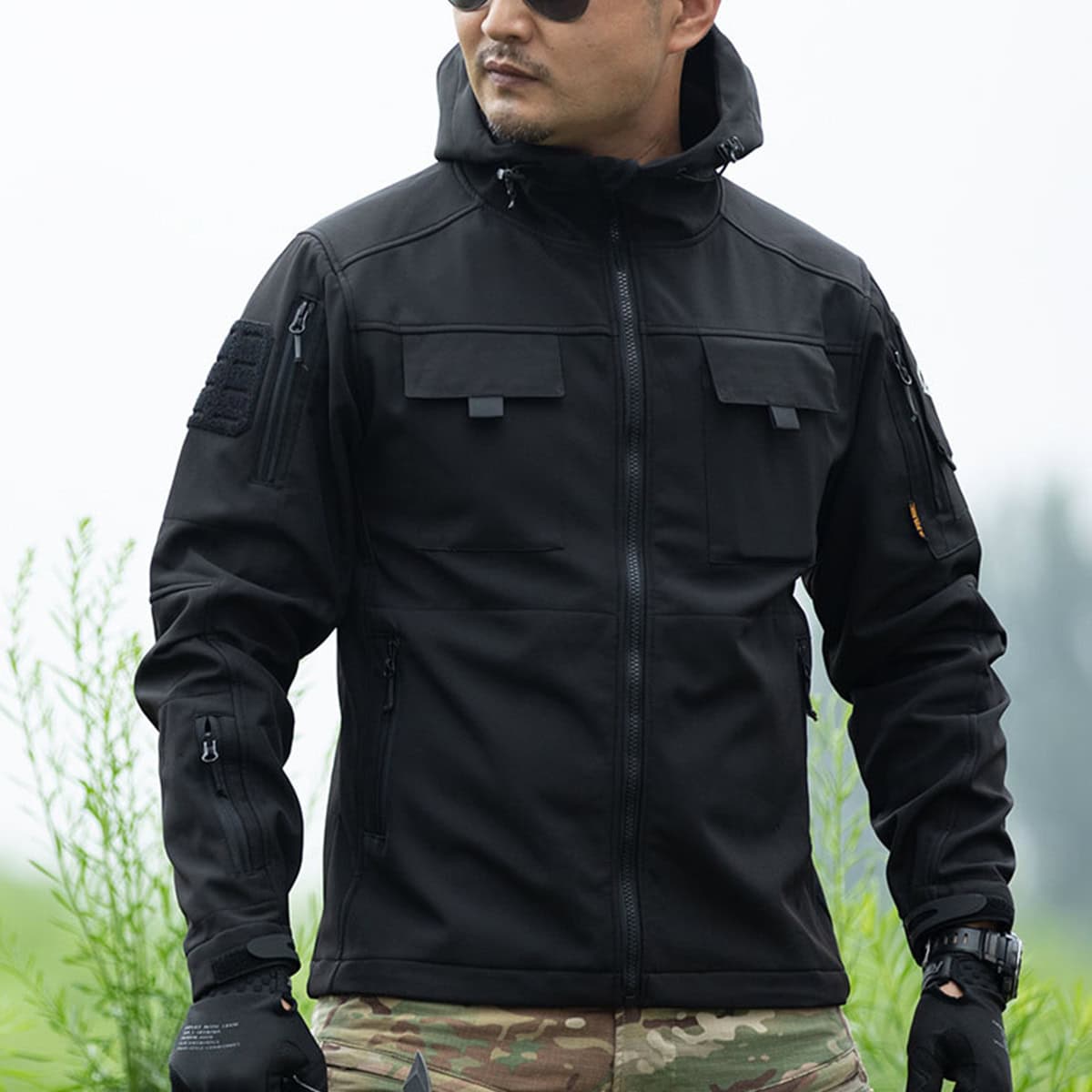 Man wearing the black version of the Onken Beetle fleece lined tactical jacket, ideal for SWAT, police, and private security uniforms.