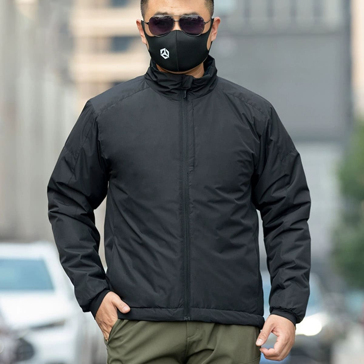 Man wearing the black Onken Gen 2 thermal reflective tactical parka, an ideal extreme cold weather jacket for police, SWAT, and high-end security details.