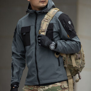 Operator wearing the grey Hooded Tactical Softshell Jacket, showcasing its athletic fit and compatibility with gear for military and security use.