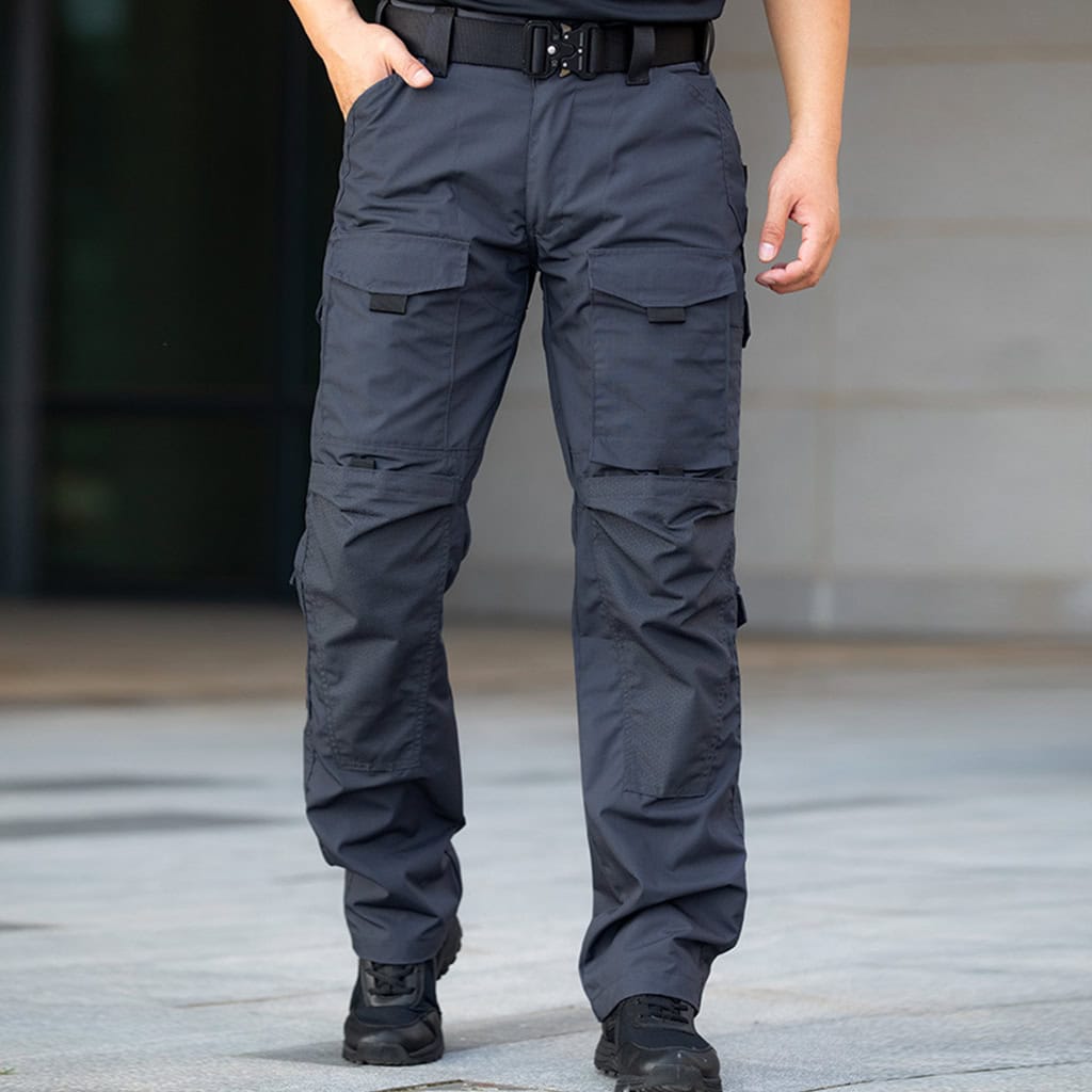 Operator wearing the grey Onken Beetle durable tactical pants, showcasing the functional cargo pockets and tough construction.