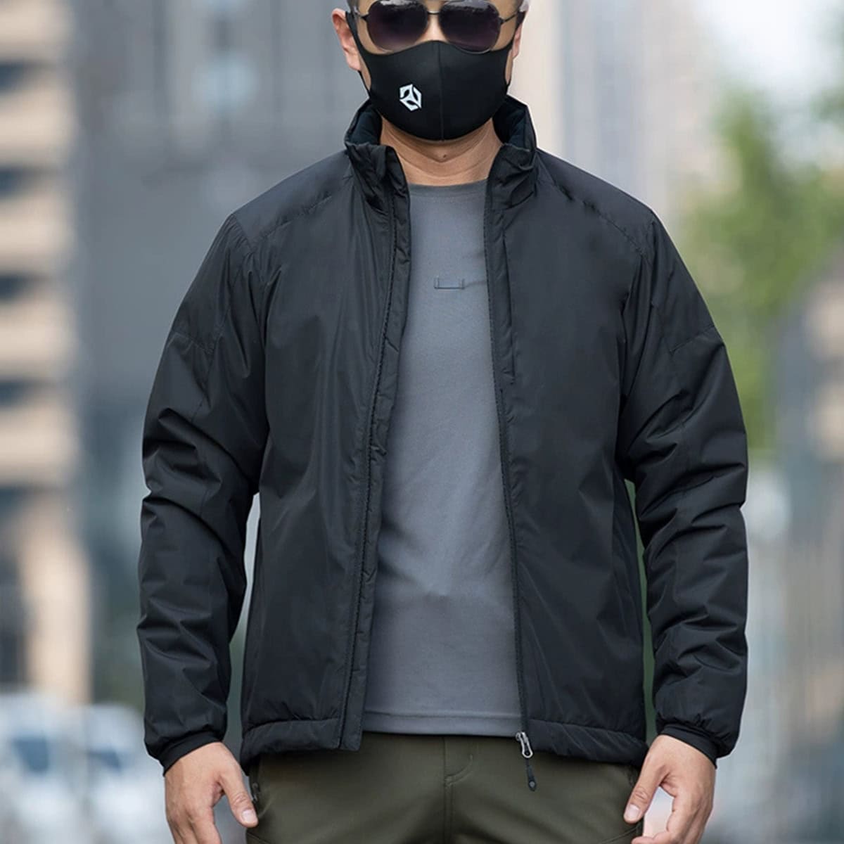Man wearing the black Onken Gen 2 thermal reflective tactical parka, an ideal extreme cold weather jacket for police, SWAT, and high-end security details.