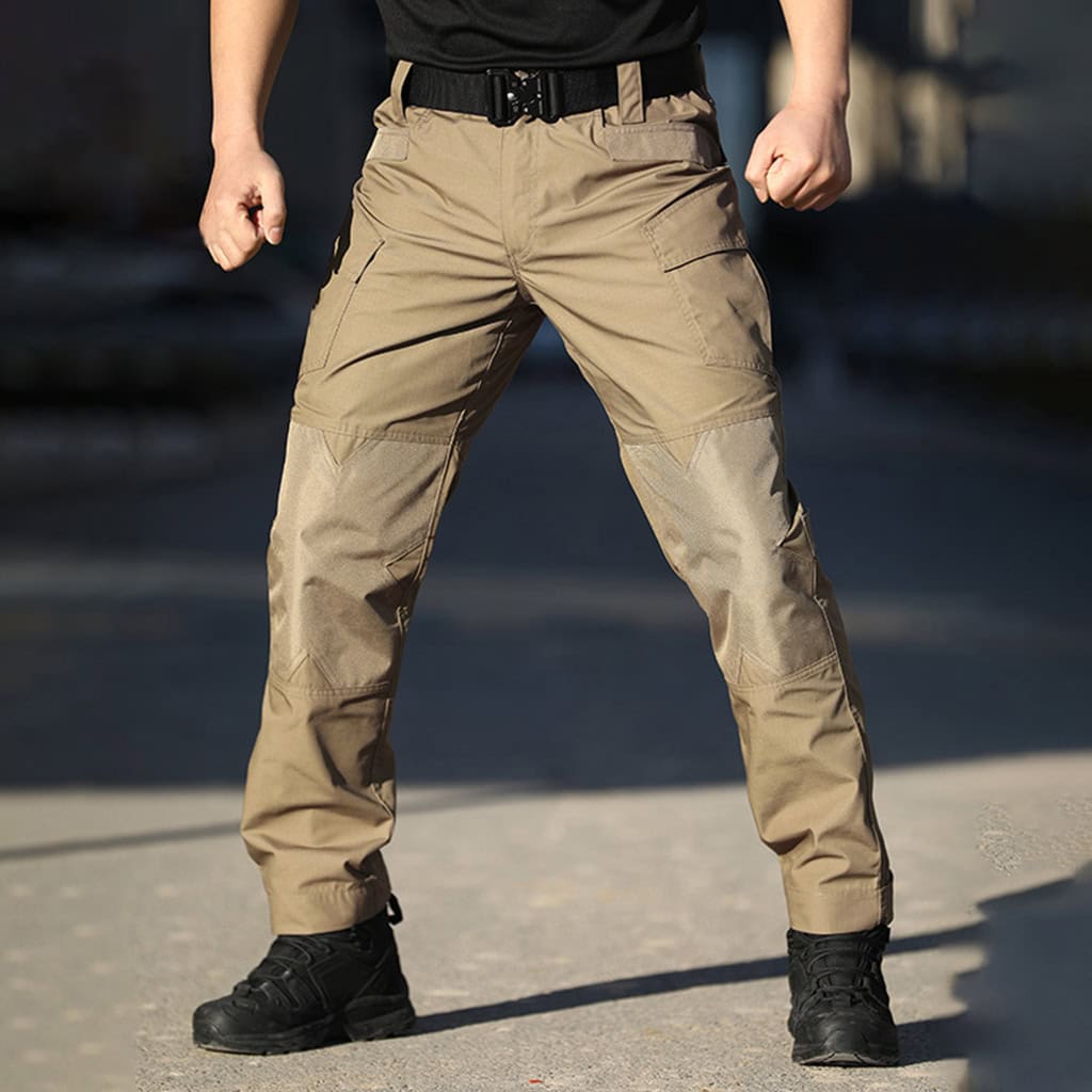Operator wearing the khaki G3 Combat Pants, demonstrating their ergonomic fit and compatibility with combat boots for special forces and SWAT teams.