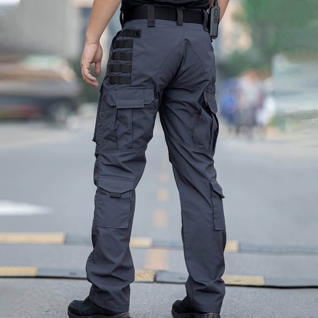 Operator wearing the grey Onken Beetle durable tactical pants, showcasing the functional cargo pockets and tough construction.