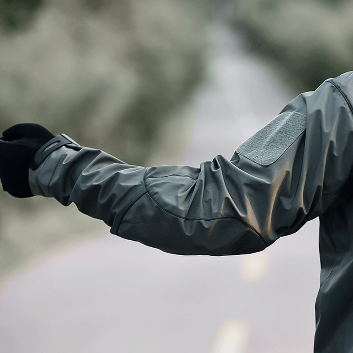 Side view of the Onken waterproof tactical jacket's sleeve, highlighting the ergonomic, articulated cut that allows for a full range of motion.