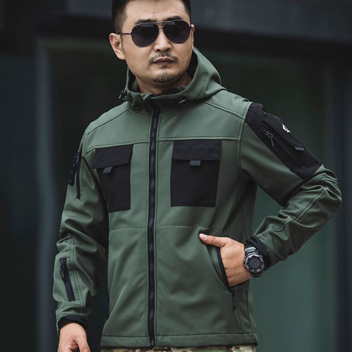 Man wearing the olive green Onken Beetle fleece lined tactical jacket, showcasing its professional profile for security details and outdoor missions.