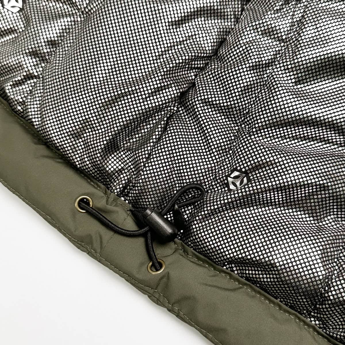 Close-up of the innovative silver-dot thermal reflective lining inside the tactical parka, which reflects body heat to provide maximum warmth in arctic conditions.