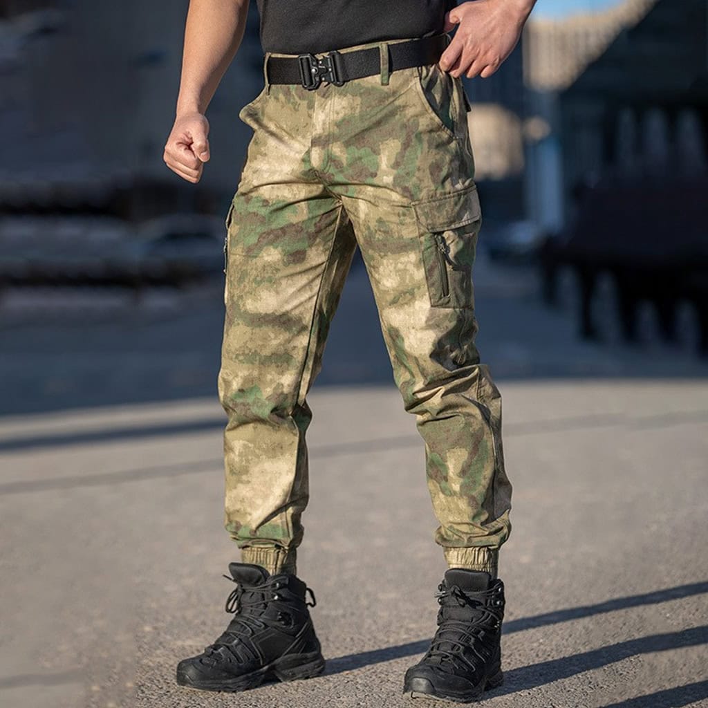 A professional wearing the camouflage Onken tactical jogger pants, showcasing their modern interface with combat boots for military and special unit use.