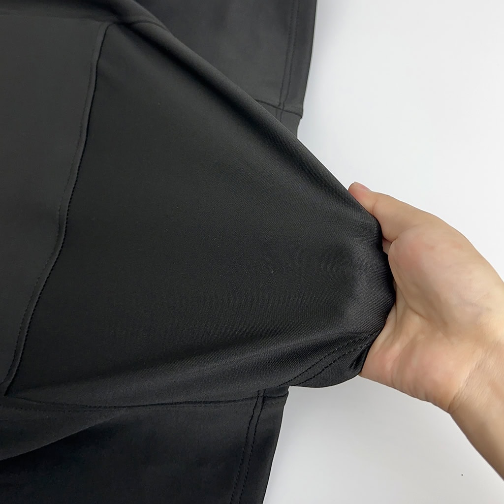 Demonstration of the 4-way stretch polyester fabric of the Aegis deep concealment body armor, providing unrestricted mobility.