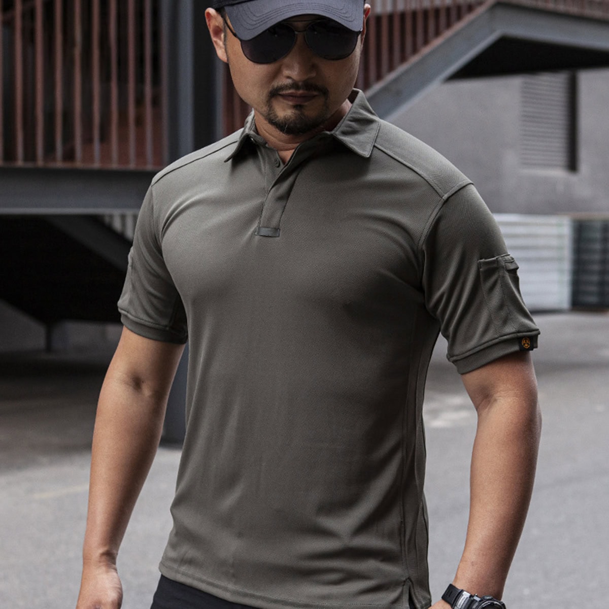 A professional wearing the olive green CMAX moisture-wicking tactical polo, demonstrating its athletic fit and professional appearance.