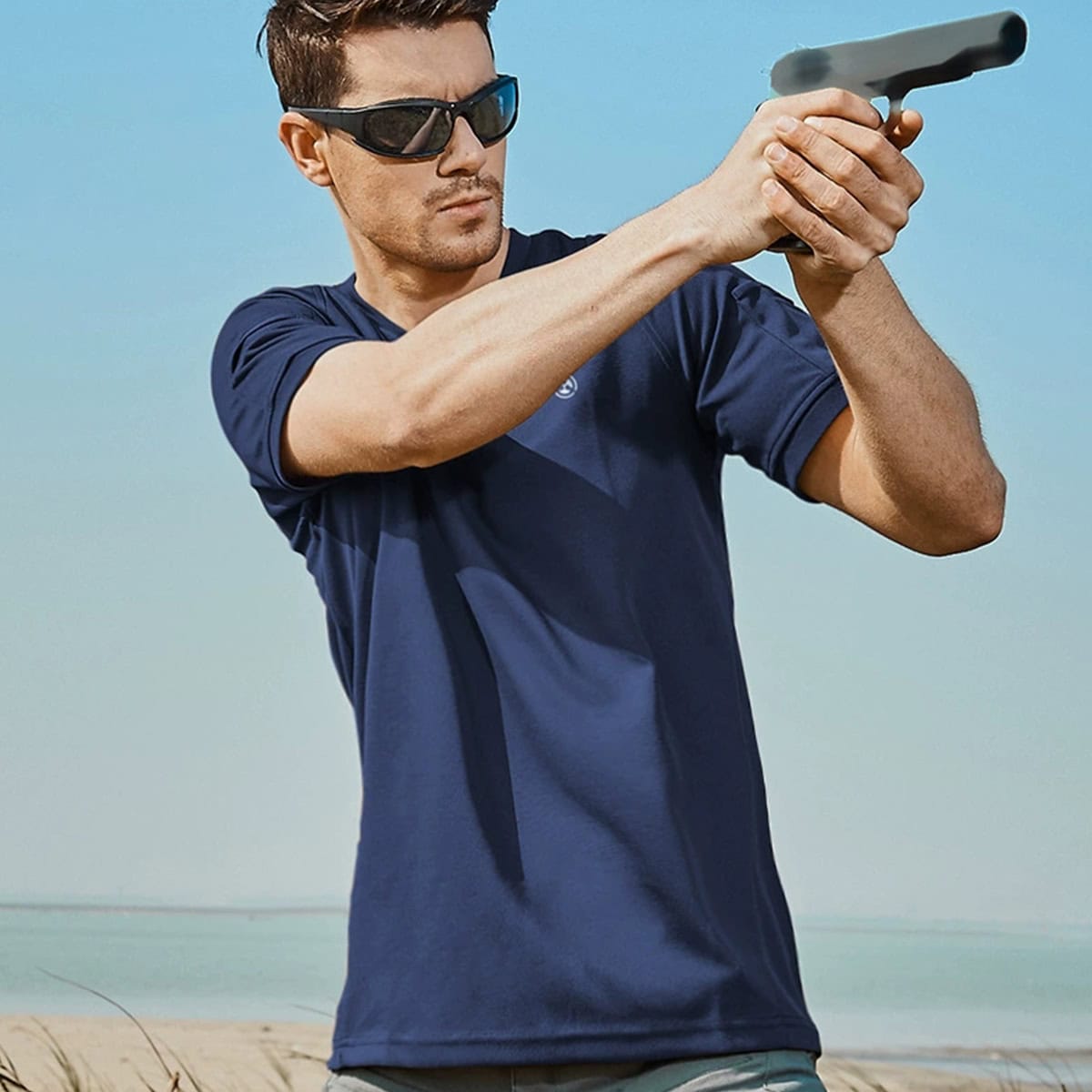 Operator wearing the navy blue CMAX moisture-wicking tactical t-shirt during a training scenario, showcasing its superior mobility.