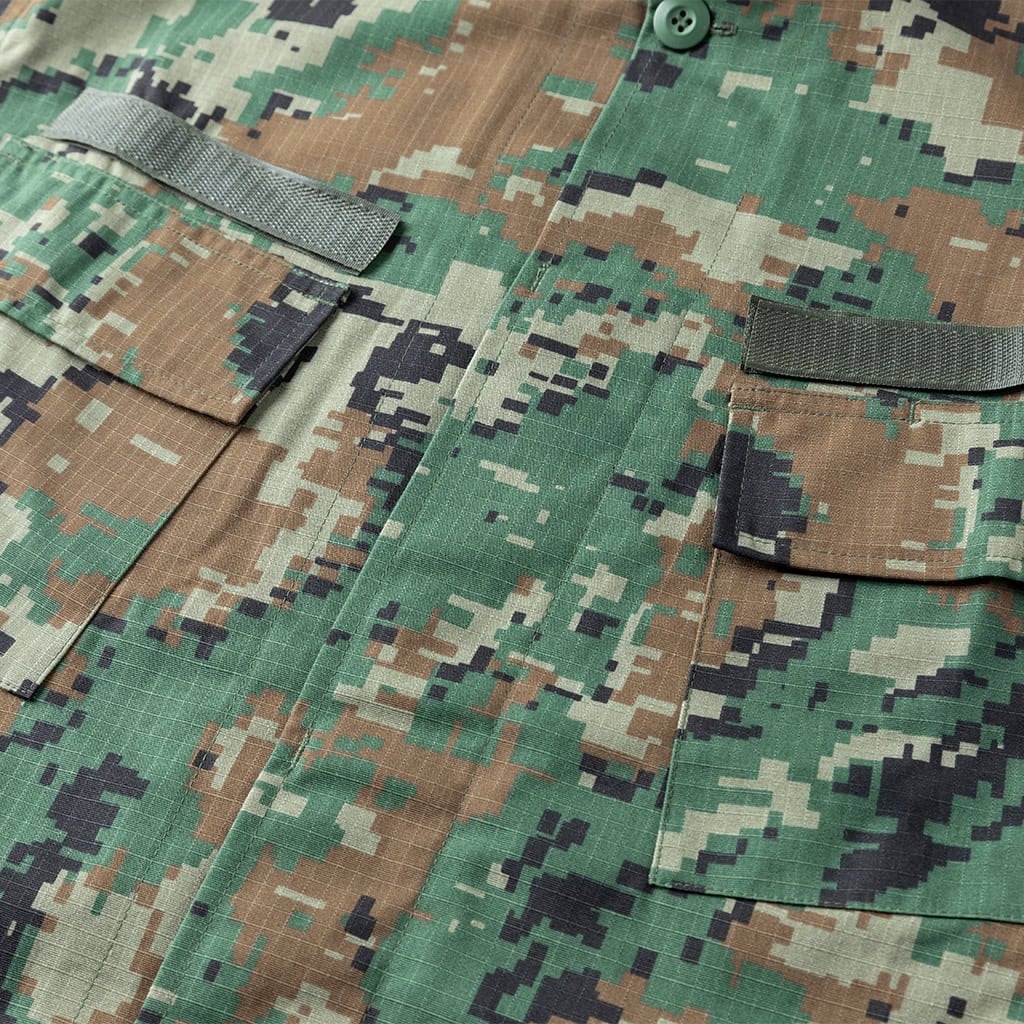 Close-up of the slanted, velcro-flapped breast pocket on the ACU Combat Uniform, designed for easy access while wearing body armor.