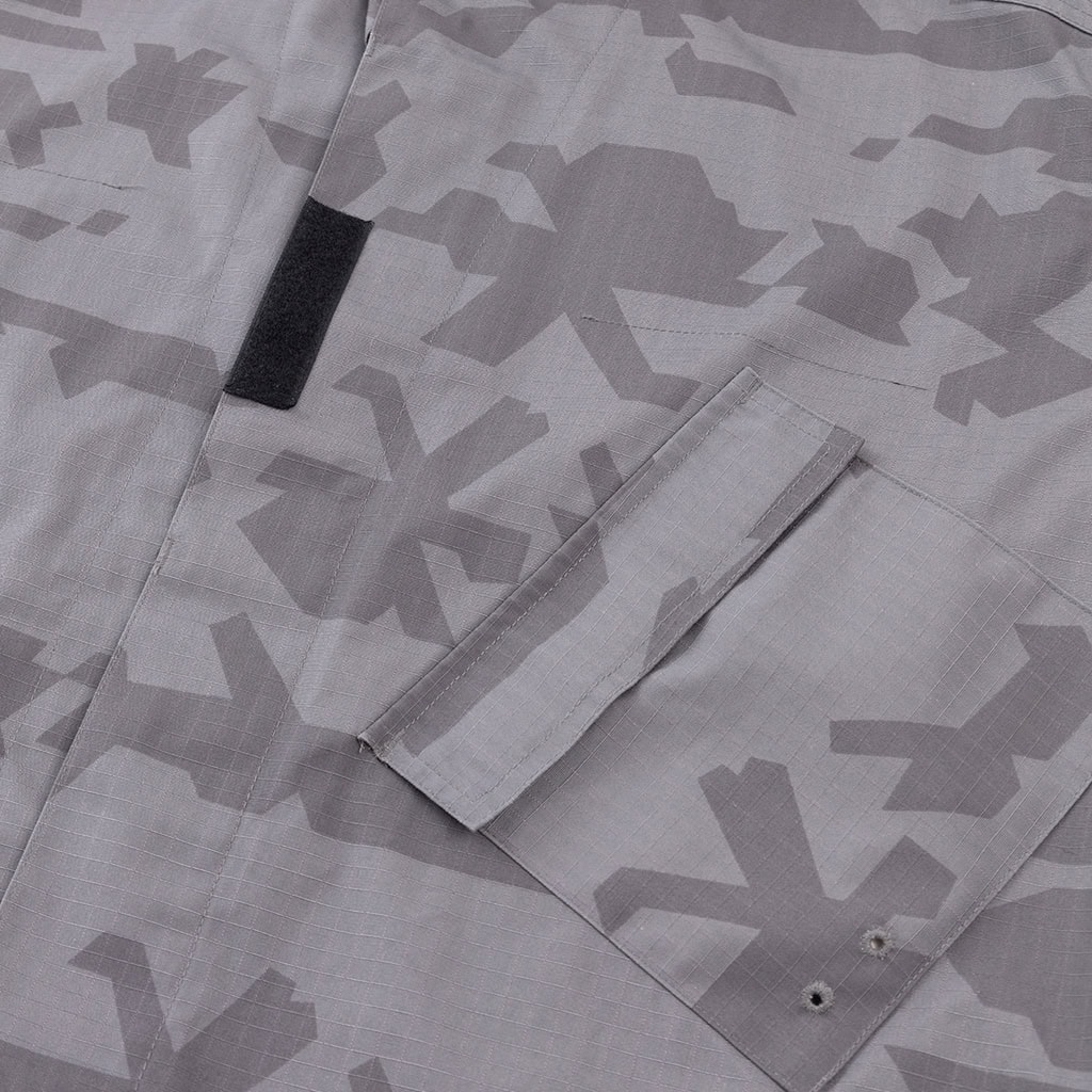 Close-up of the slanted, velcro-flapped breast pocket on the Urban Camo ACU, designed for easy access while wearing body armor.