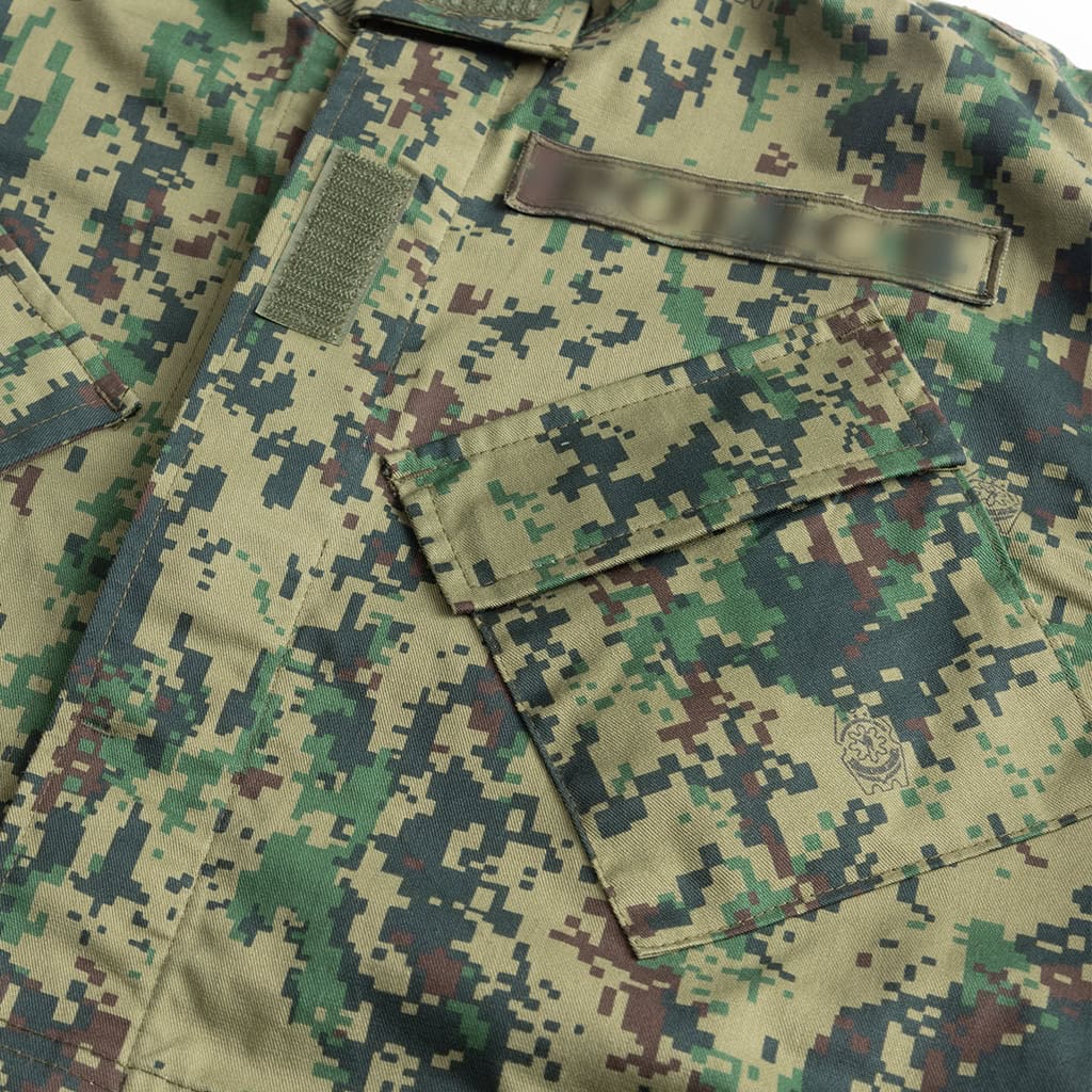 Close-up of the slanted, velcro-flapped breast pocket on the Jungle Digital ACU, designed for easy access while wearing a plate carrier.