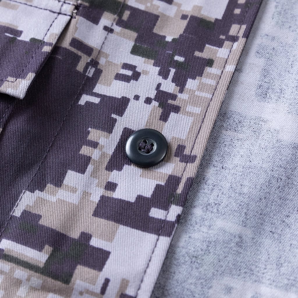 Close-up of the button-flapped breast pocket on the Arid Digital Camo BDU jacket.
