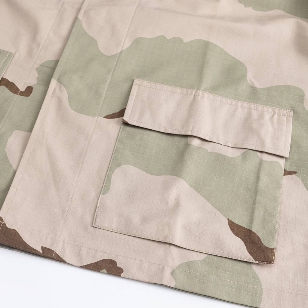 Close-up of the button-flapped bellowed breast pocket on the 3-Color Desert BDU jacket, providing secure storage for essential gear.
