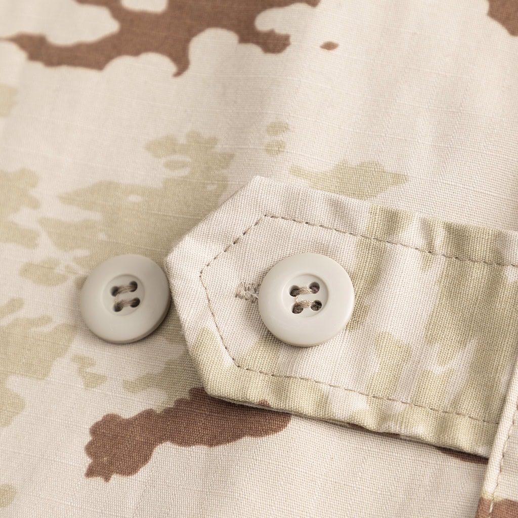 Close-up of the shoulder epaulet and custom patches on the Classic Jungle Camo BDU, showcasing customization options for B2B contracts.