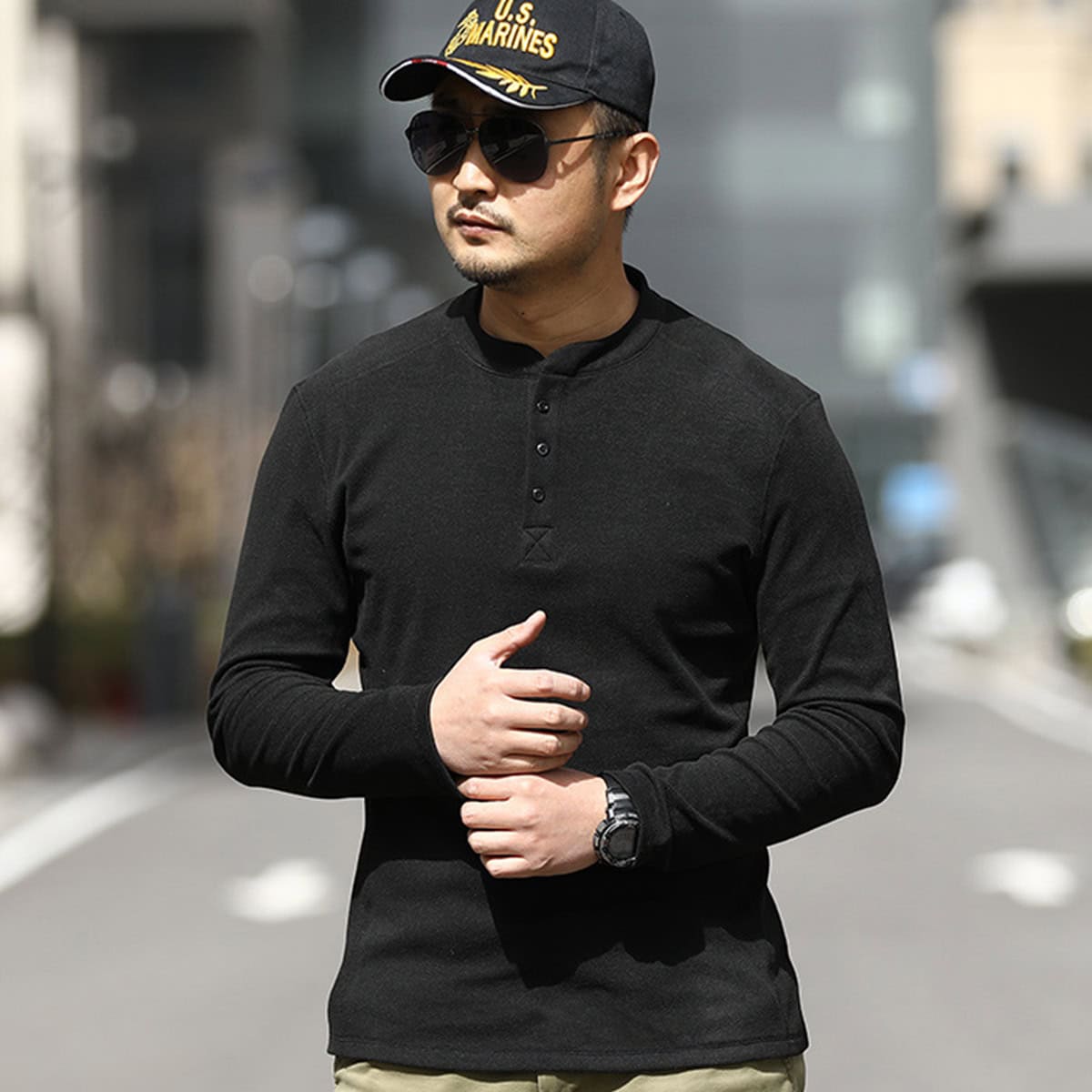 A professional wearing the black Warhorse performance tactical henley, demonstrating its athletic fit and suitability for plainclothes or covert duty.