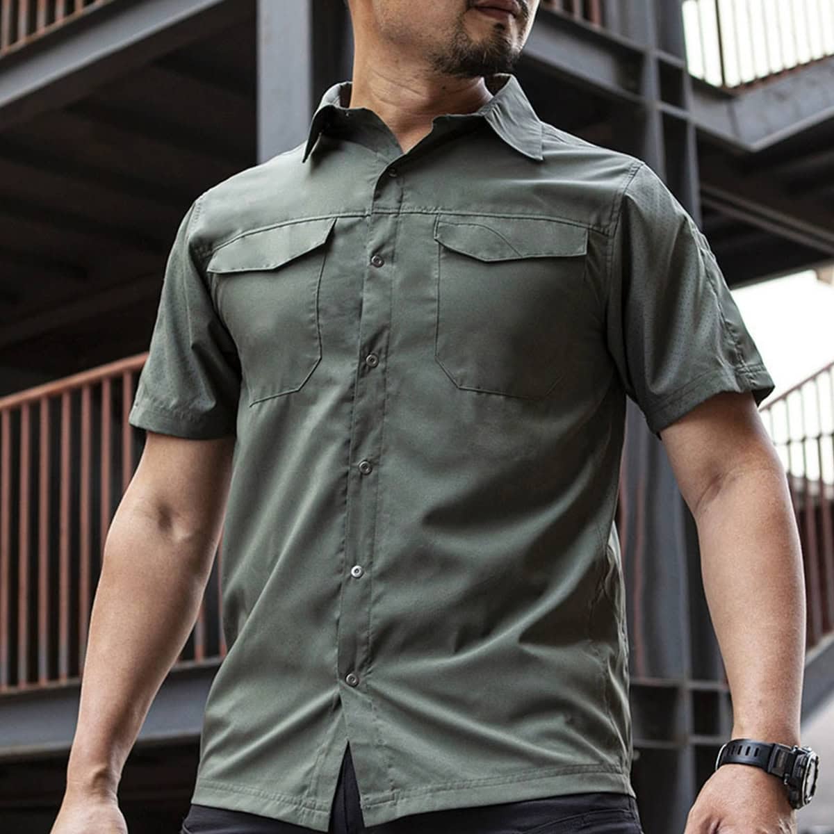Operator wearing the olive green "Sharp Edge" breathable tactical shirt, showcasing its comfort and professional look for warm weather duty.
