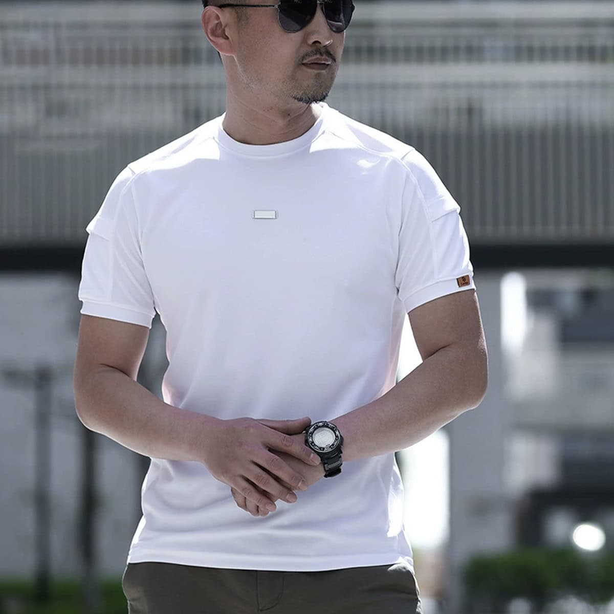 Man wearing the white CMAX moisture-wicking tactical t-shirt, highlighting its clean, professional look for plainclothes or corporate security roles.