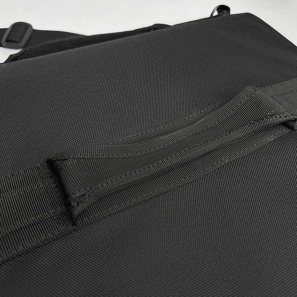 Detail of the interior handheld strap on the deployed ballistic briefcase, allowing for a secure grip to use it as a shield during an emergency.