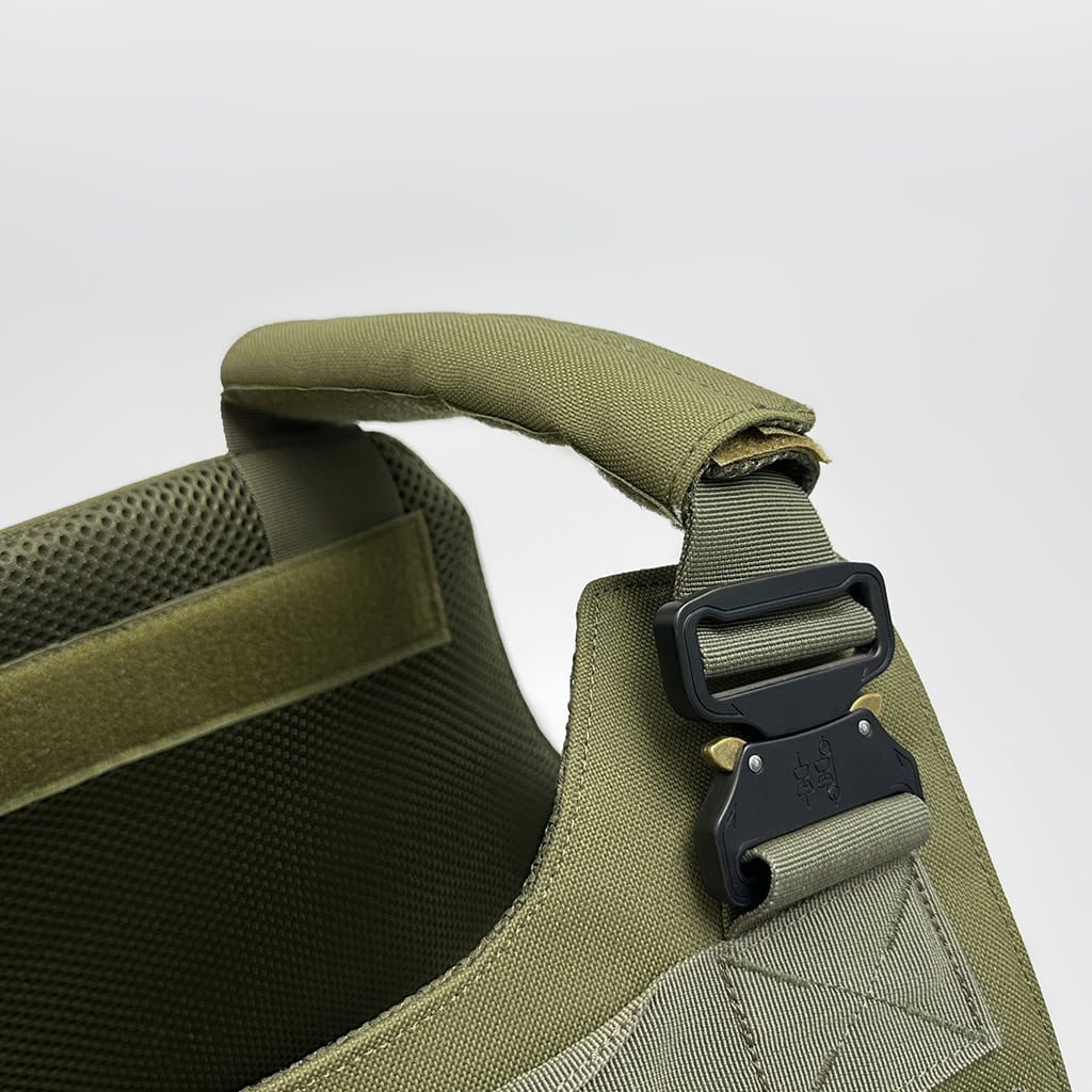 Detail of the "Praetorian" armor's padded shoulder strap with a heavy-duty quick-release Cobra-style buckle for emergency doffing.