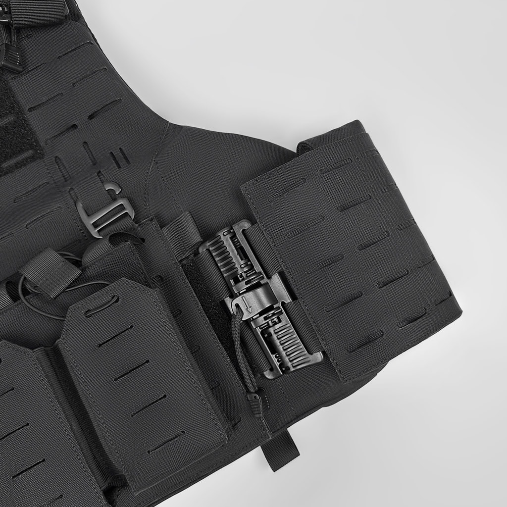 Close-up of the cummerbund quick-release buckle on the "Spartan" plate carrier, allowing for rapid, single-handed removal.