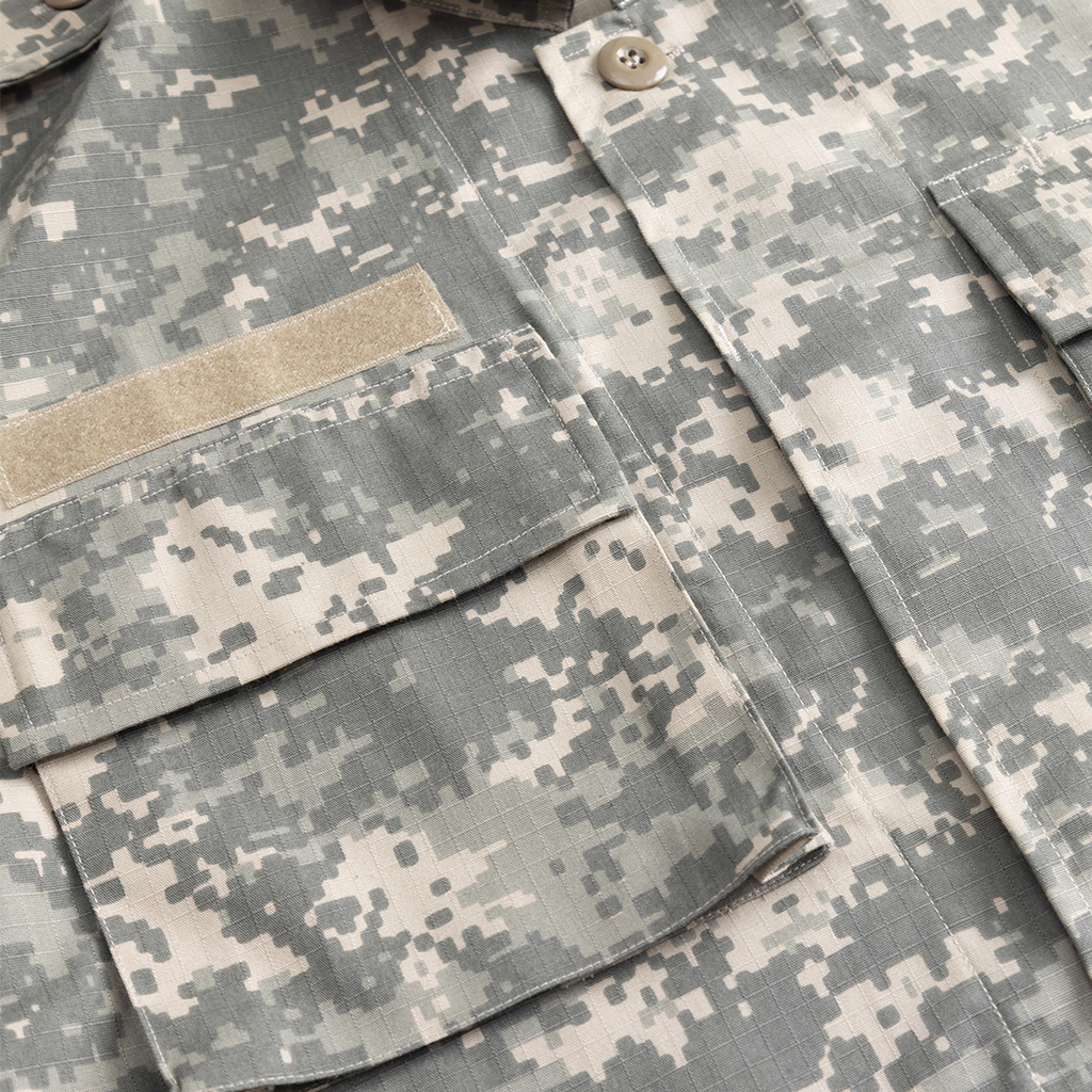 Close-up of the breast pocket and velcro patch on the digital camo ACU combat uniform shirt.