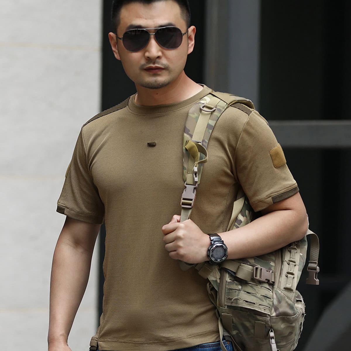 A professional in the coyote brown advanced moisture wicking t-shirt, the ideal base layer for military and special operations personnel in arid environments.
