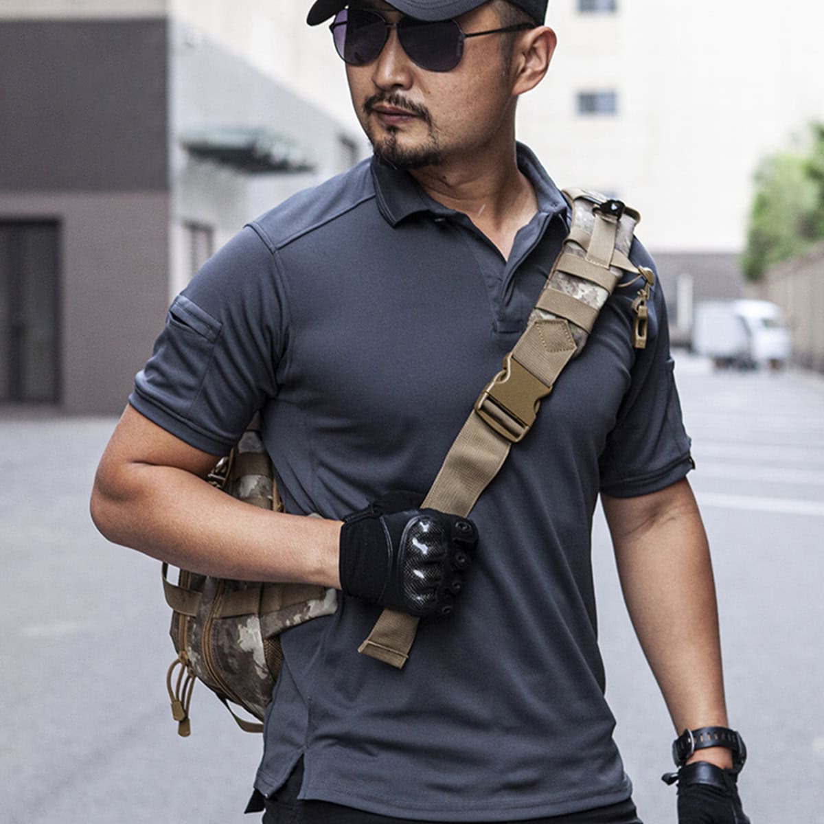 Operator wearing the grey CMAX moisture-wicking tactical polo with gear, highlighting its compatibility with tactical equipment.