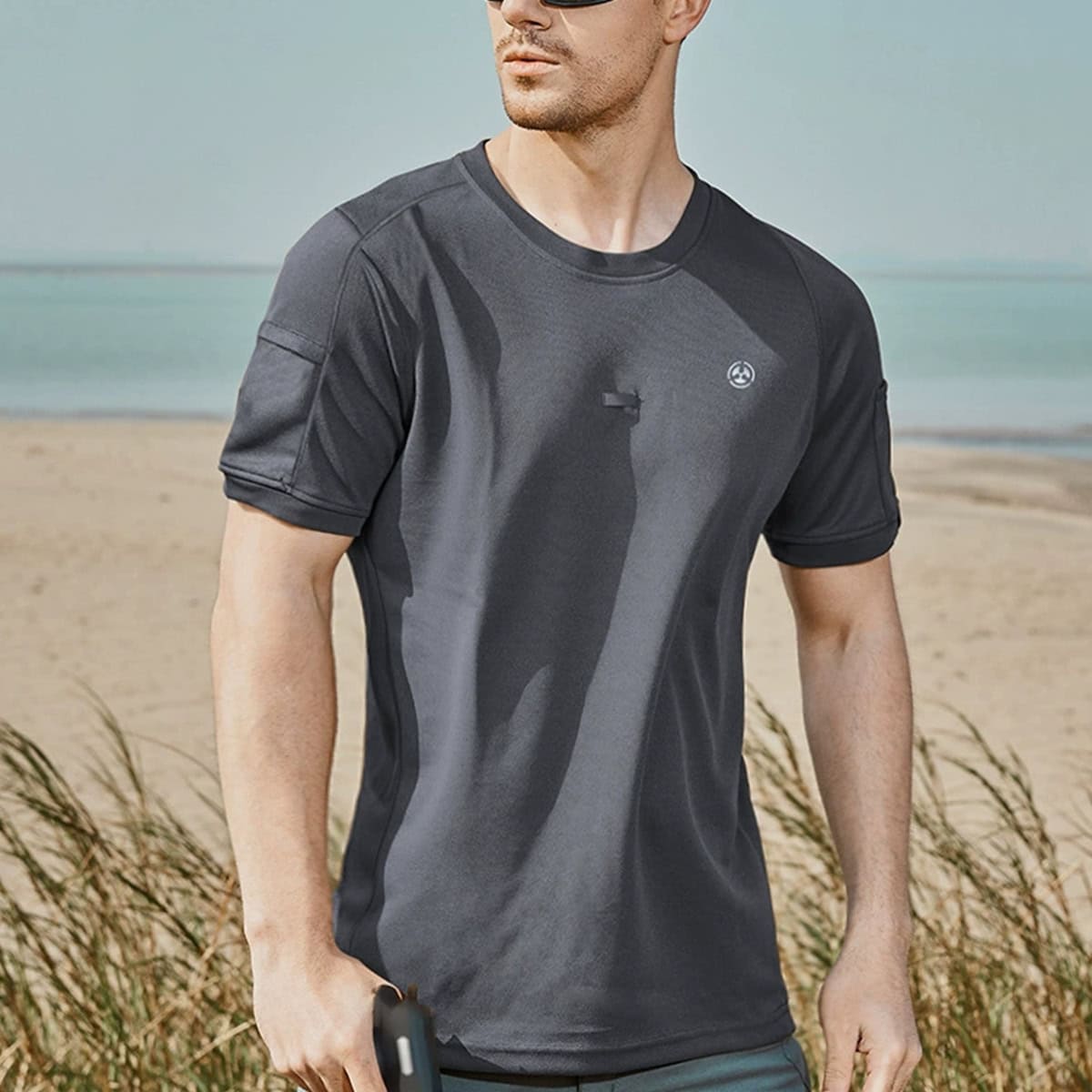 A professional in the grey CMAX moisture-wicking tactical t-shirt, the perfect base layer for comfort and performance.