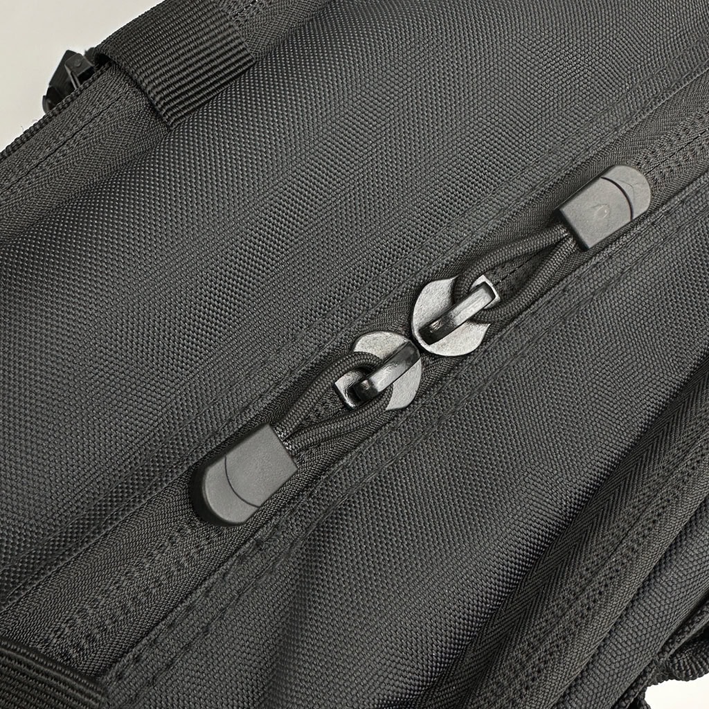 Close-up of the durable, oversized double zippers on the main compartment of the Pathfinder Laser-Cut Tactical Backpack.