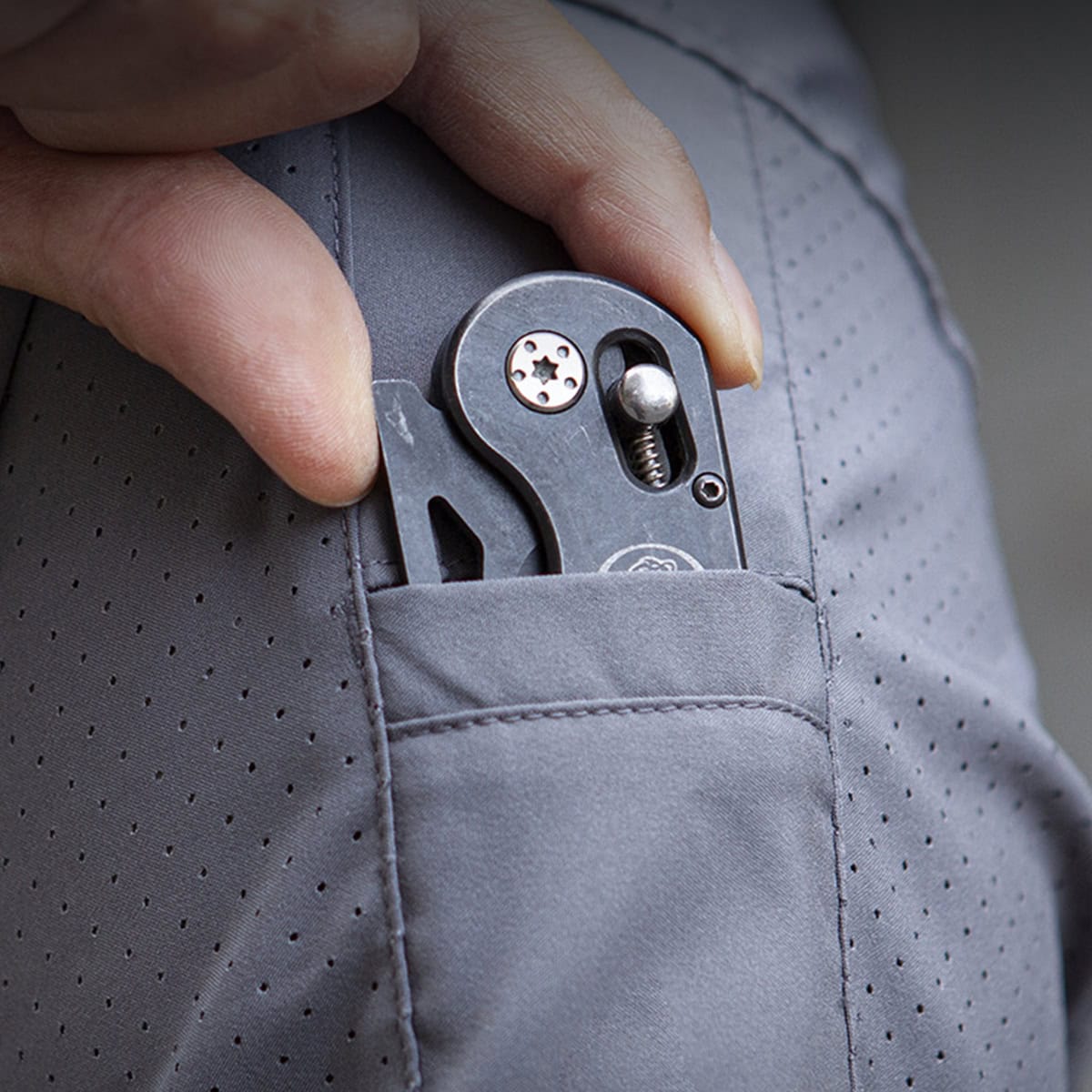 Close-up showing the micro-perforated, breathable fabric of the "Sharp Edge" tactical shirt, engineered for maximum airflow in hot weather.