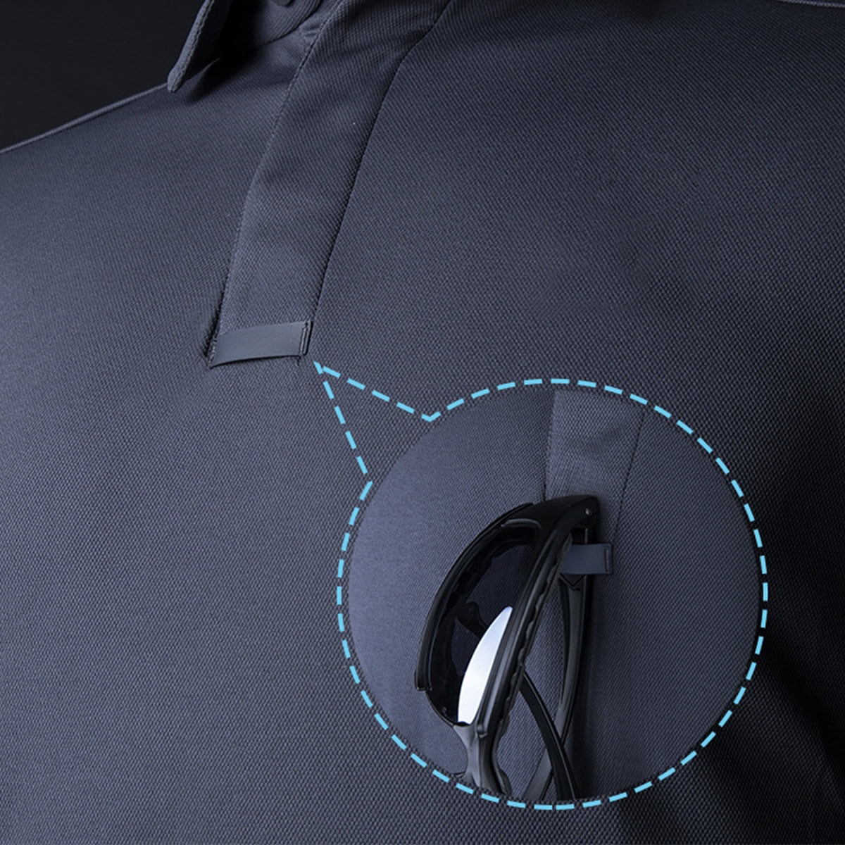 Close-up of the integrated sunglasses and microphone clip loop on the CMAX tactical polo, a key feature for law enforcement and security professionals.