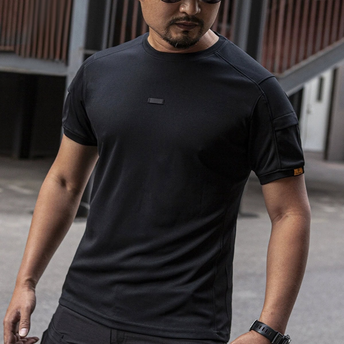 A professional wearing the black CMAX moisture-wicking tactical t-shirt, an essential component for any law enforcement or security uniform.