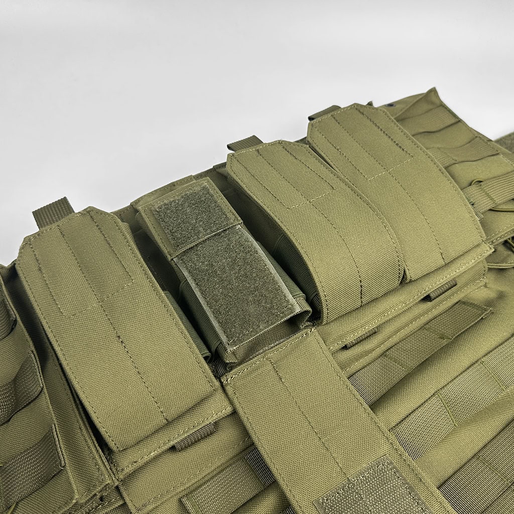 Detail showing the integrated rifle and pistol magazine pouches on the front of the JPC MOLLE Plate Carrier, providing a ready-to-go loadout.