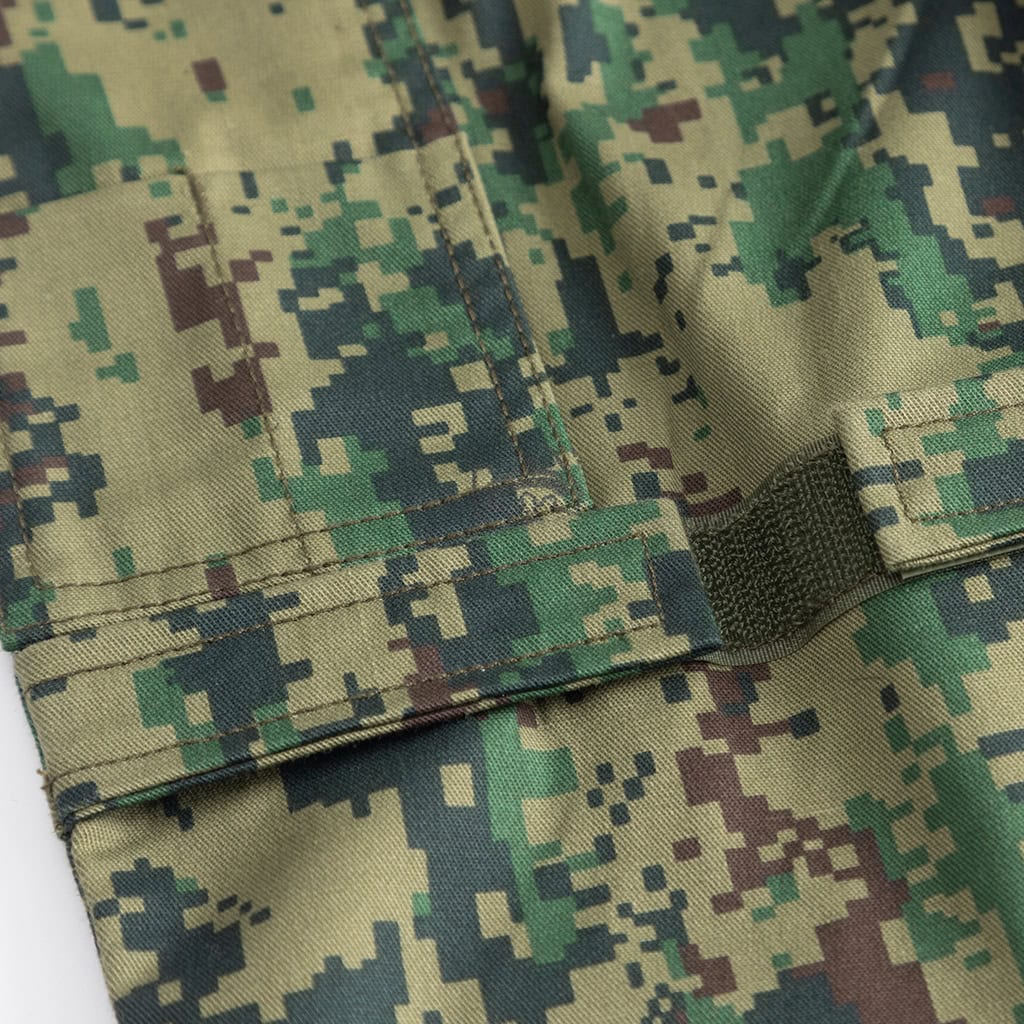 Close-up of the large, pleated cargo pocket on the Jungle Digital ACU trousers, providing ample storage for mission essentials.