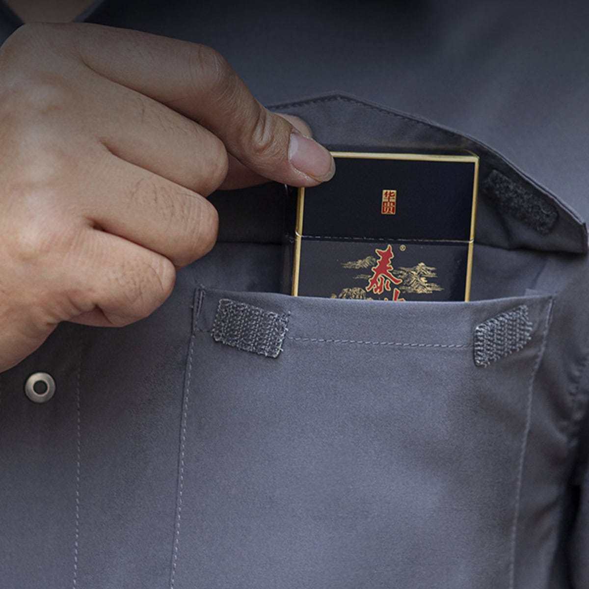 Close-up of the hidden vertical chest pocket on the "Sharp Edge" breathable tactical shirt, designed for covertly storing documents or a phone.