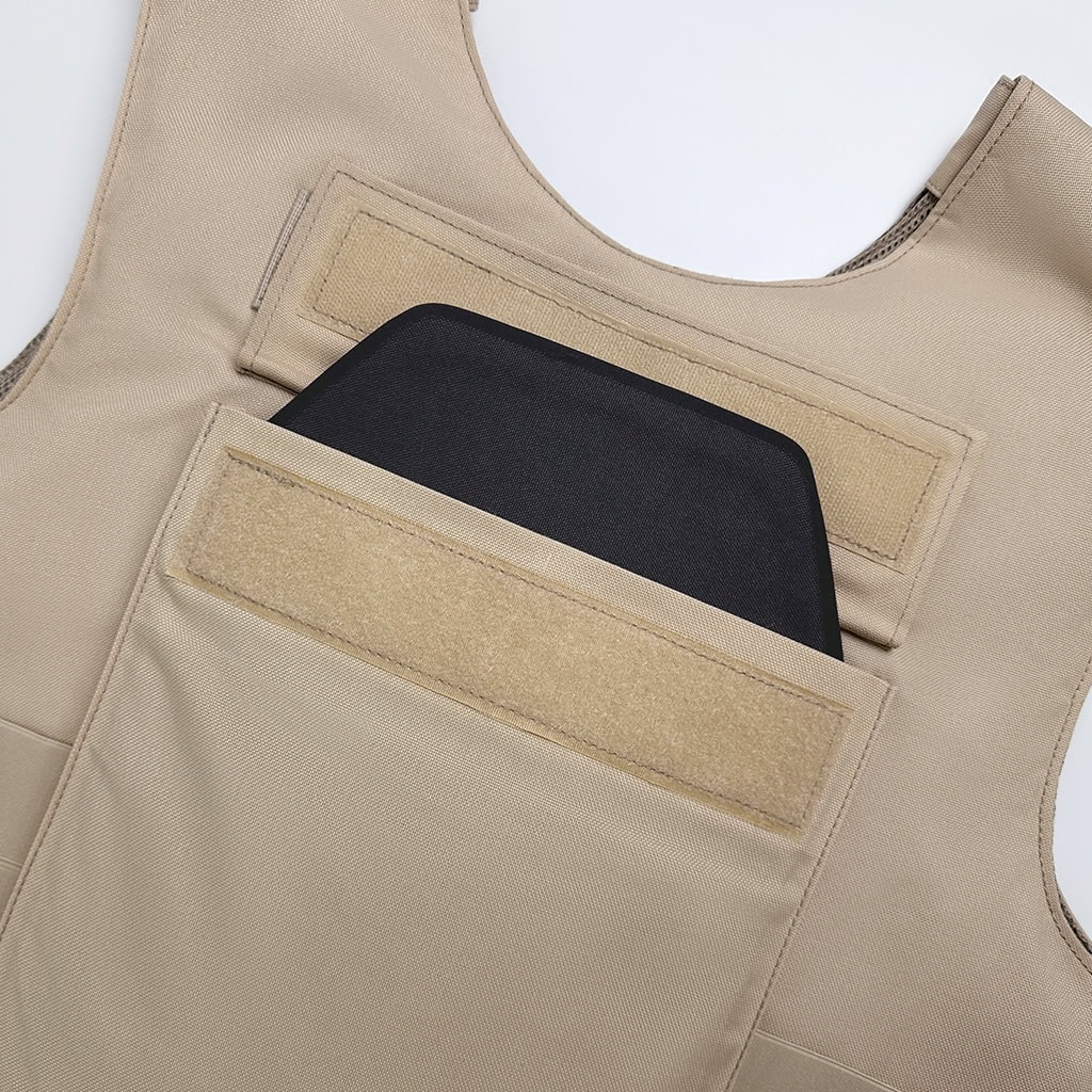 Detail showing the "Press" vest's internal pocket, compatible with both soft and hard armor plates for adaptable NIJ-rated protection.