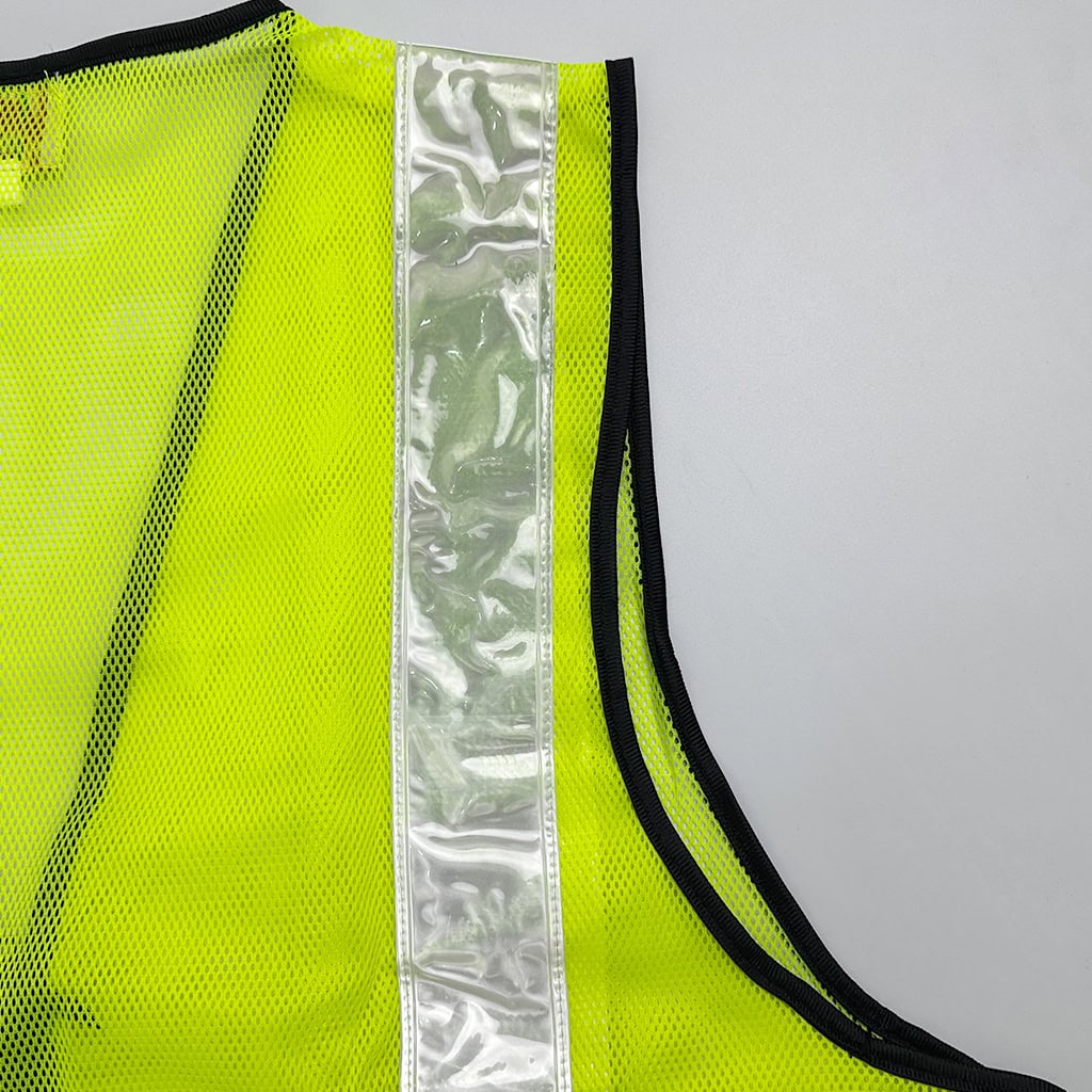 Detail of the high-intensity reflective stripe on the ANSI Class 2 safety vest, which meets EN20471 and ANSI 107 standards for nighttime visibility.