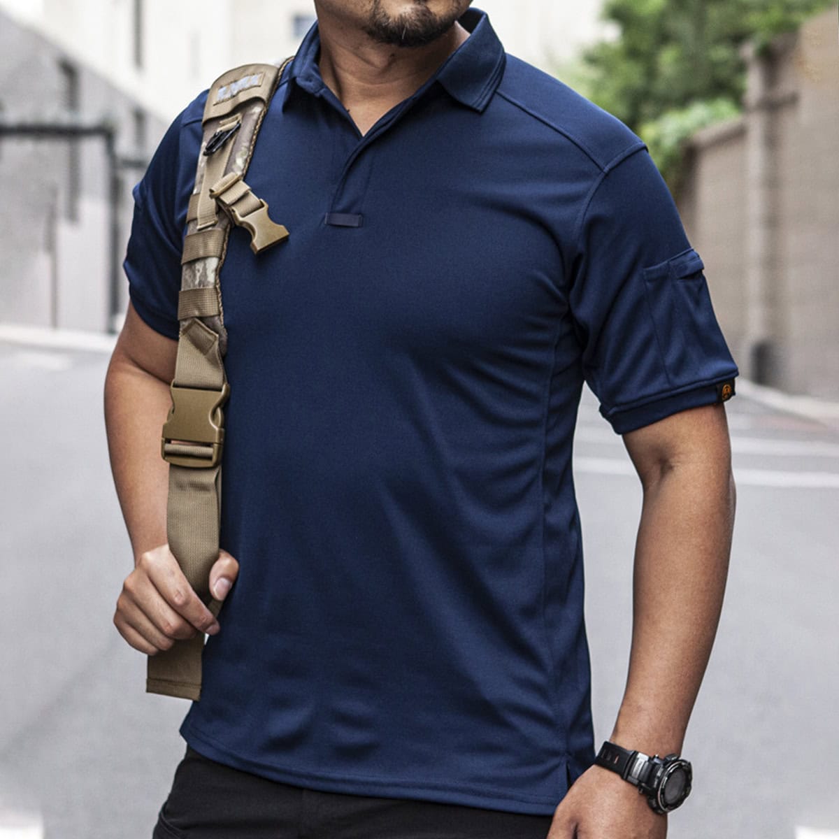 Man wearing the navy blue CMAX moisture-wicking tactical polo, the perfect uniform shirt for corporate security and event staff.