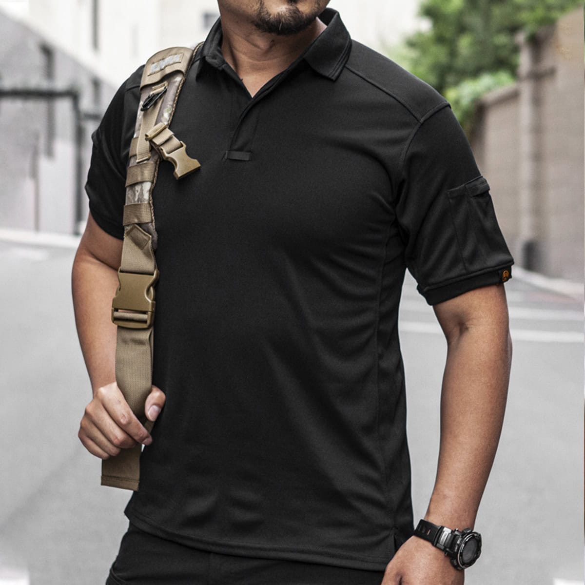 A professional in the black CMAX moisture-wicking tactical polo, a sharp and durable option for law enforcement and security B2B contracts.
