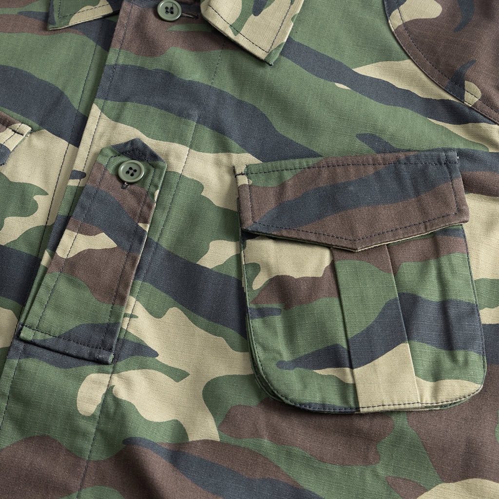 Close-up of a bellowed breast pocket on the custom woodland camo combat uniform jacket.