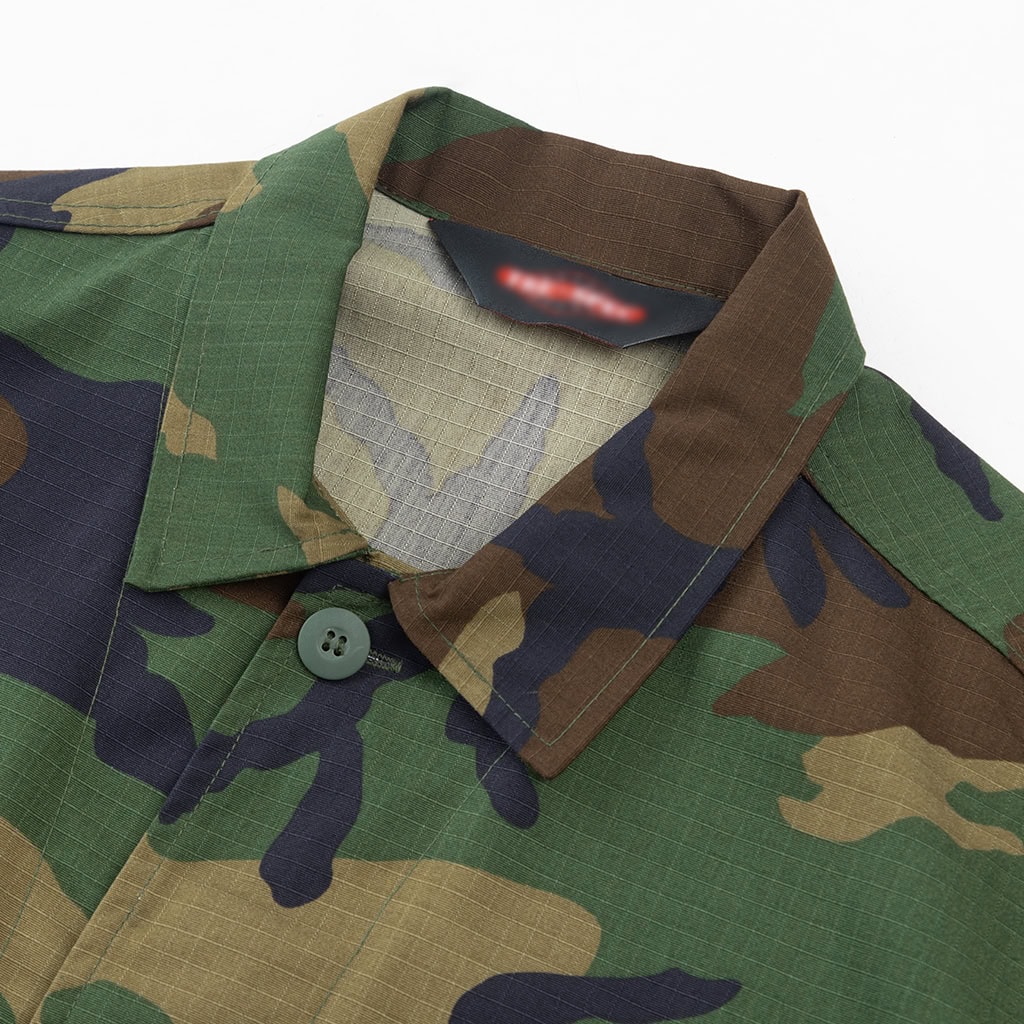 Close-up detail of the traditional buttoned collar on the custom woodland camo BDU uniform jacket.