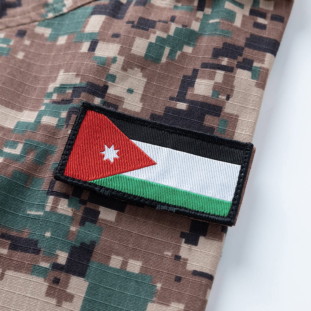 Close-up of the Jordanian flag patch on the sleeve of the custom digital camo combat uniform.
