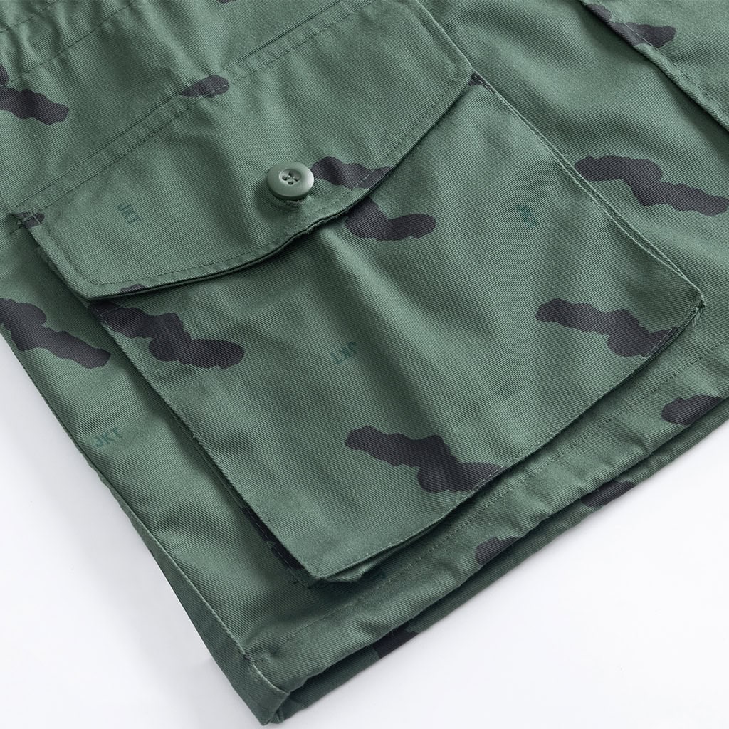 Close-up of the buttoned breast pocket on the custom Tanzanian green camo uniform jacket.